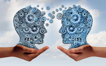 Illustration of two human profiles facing each other, composed of interlocking blue gears and cogs. Each head is supported by a large hand, set against a cloudy sky background, symbolizing ideas and communication.