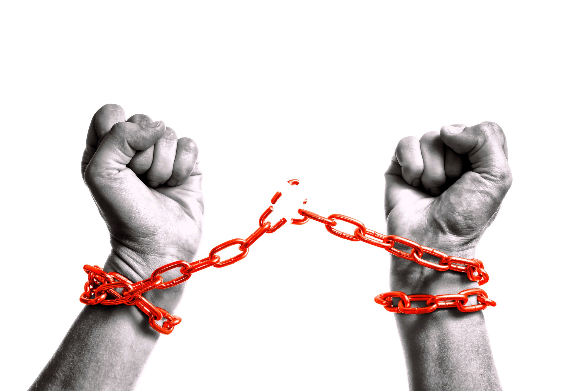 A pair of hands breaking free from red chains against a white background. The fists are clenched, symbolizing liberation or breaking free from constraints.