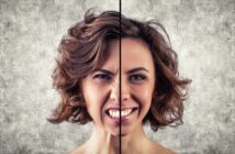 A split image of a woman showing contrasting emotions. The left side of her face appears angry and frustrated with a furrowed brow and half her mouth frowning, while the right side is smiling and happy, with relaxed features and a bright expression against a textured background.