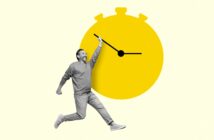 A man in grayscale appears joyful while holding one of the hands of a large, bright yellow stopwatch, which creates a playful and dynamic feel. The background is light yellow, accentuating the image's energetic and whimsical nature.