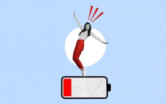 A woman in red pants and a striped shirt balances on a large, low-battery icon against a light blue background. Red exclamation marks above her head suggest urgency or surprise.