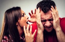 A woman with long brown hair is yelling; her hand is raised in frustration. A man with short curly hair, wearing a red shirt, is holding his hands to his head, showing distress or frustration. Both express intense emotions.