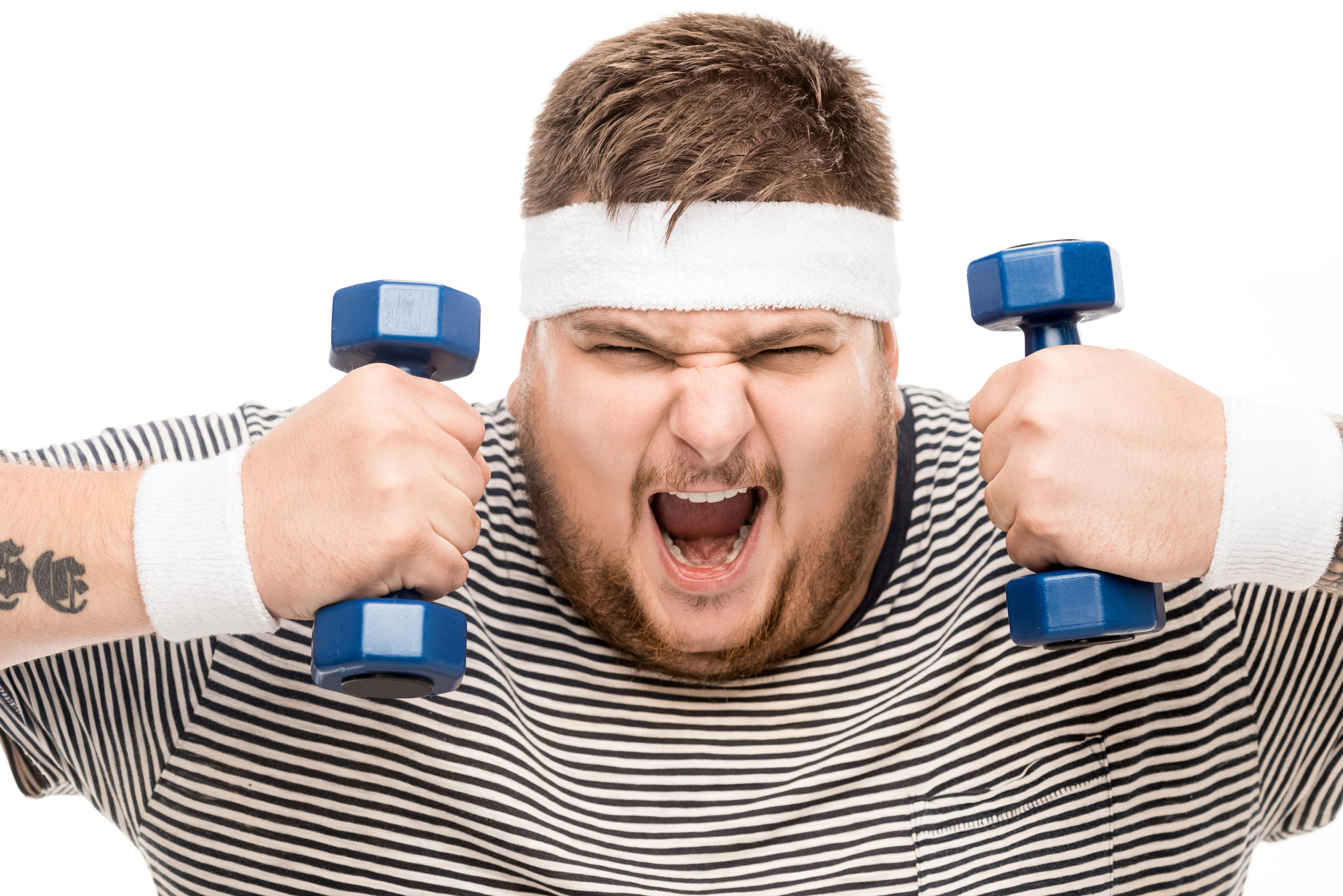 A person wearing a striped shirt, a white headband, and wristbands is energetically lifting two small blue dumbbells against a white background. They have an intense expression, showcasing determination and effort.